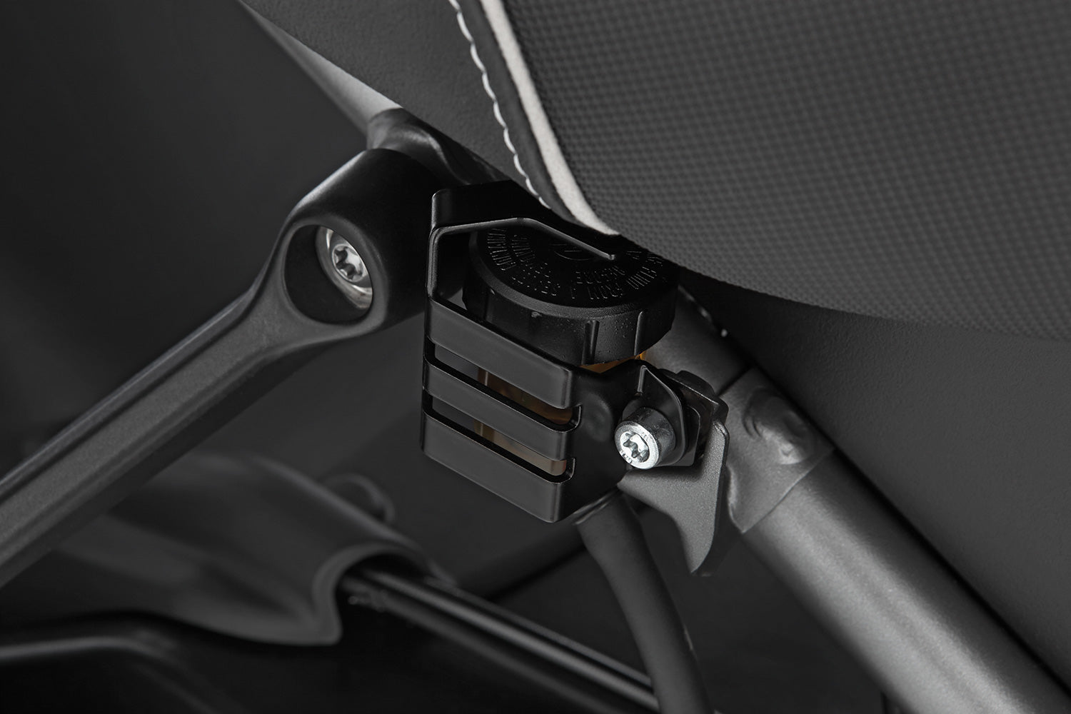 Discreetly integrated protective cover for the rear wheel brake fluid reservoir