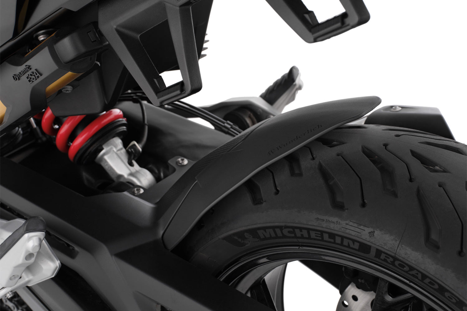 The area around the swing arm pivot, the swing arm, the collector, the gears and the shock absorber are in front of the rear wheel and thus