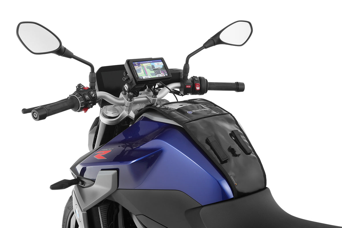 The mounting system is attached to the vehicle with minimal hand pressure and the tank bag can be quickly fastened to it.