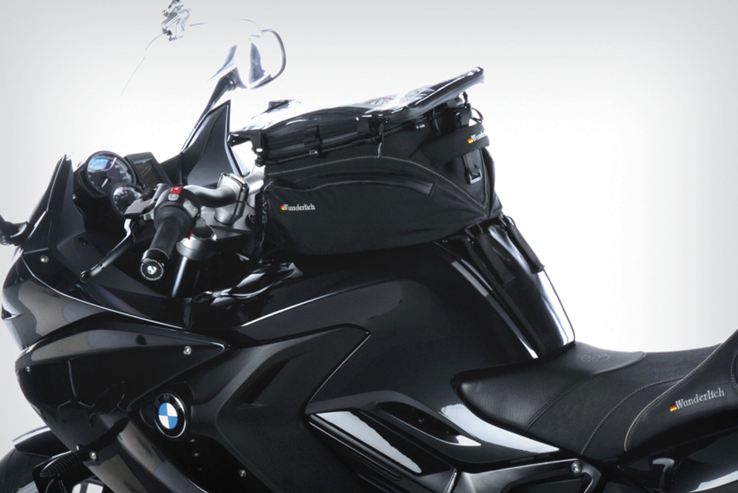 The mounting system is attached to the vehicle with minimal hand pressure and the tank bag can be quickly fastened to it. 
