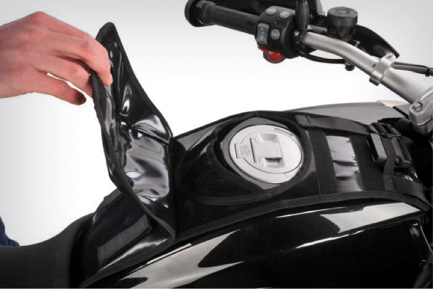 The mounting system is attached to the vehicle with minimal hand pressure and the tank bag can be quickly fastened to it. 